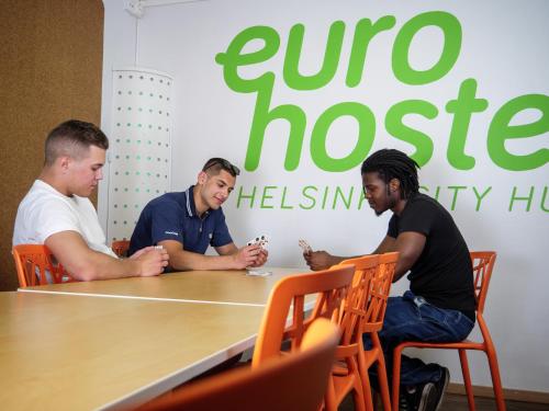 a group of men sitting around a table at Eurohostel in Helsinki