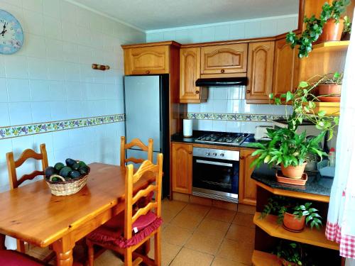 a kitchen with a wooden table and a refrigerator at Simón in Barlovento