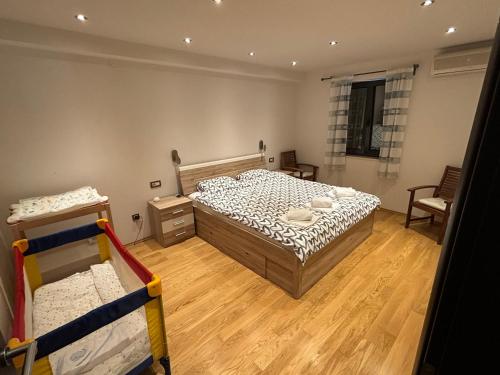 a bedroom with a bed and two bunk beds at Apartment Verano in Njivice