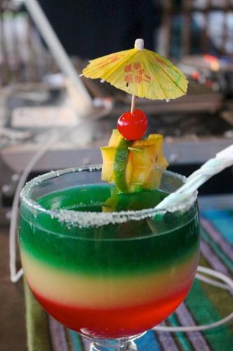 a drink with an umbrella on a table at Hotel El Delfin in Monterrico