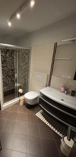 a bathroom with a tub and a toilet and a shower at Apartment Verano in Njivice