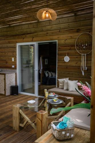 a living room with a couch and a table at Monkey Tiny House - Private swimming pool in Big Bight