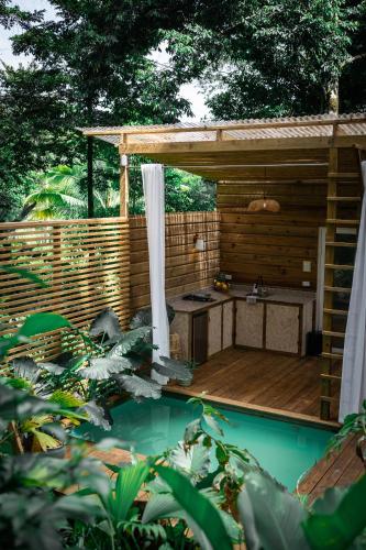 a pergola next to a pool in a backyard at Monkey Tiny House - Private swimming pool in Big Bight