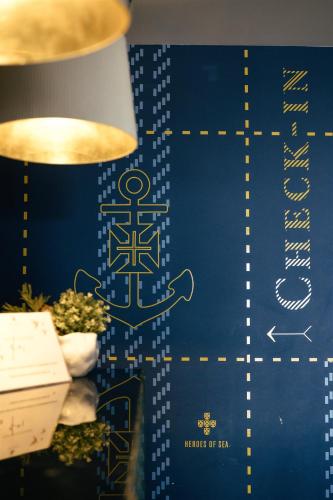 a blue and gold wall with a sign on it at Macarico Beach Hotel in Praia de Mira