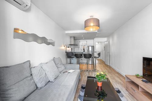 un salon avec un canapé gris et une table dans l'établissement Very NICE - 80 meters to the sea, à Nice