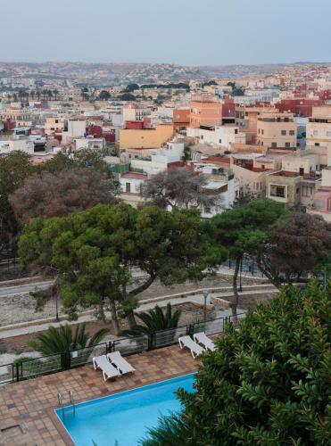 a view of a city from a resort with a swimming pool at Parador de Melilla in Melilla