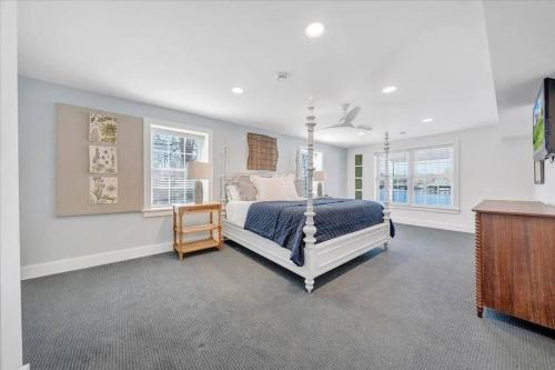a bedroom with a bed and two windows at 6 BD Smith Mountain Lakefront Escape sunset in Moneta