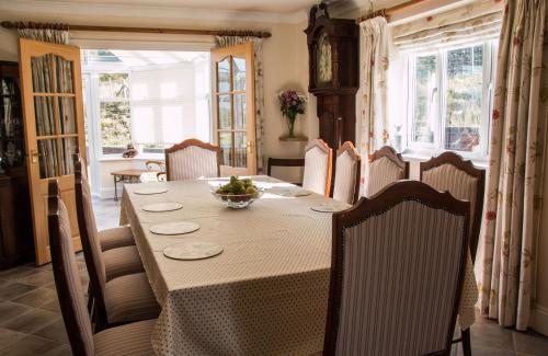 a dining room with a table and chairs at Applewood in Much Wenlock