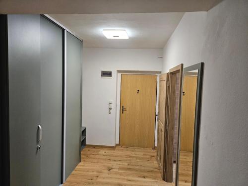 an empty hallway with two doors and wooden floors at Apartmány Skalica in Skalica
