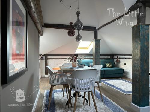 a dining room with a table and chairs at Пространства за гости Синият час - апартамент Little Wing in Ruse