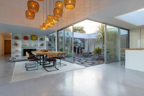 a dining room with a table and a fireplace at White Exclusive Suites & Villas in Lagoa