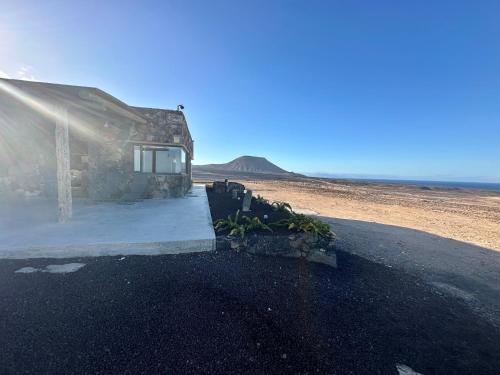 a small building in the middle of the desert at Casita Tahona con vistas de infarto al mar y volcanes con absoluta privacidad in Parque Holandes