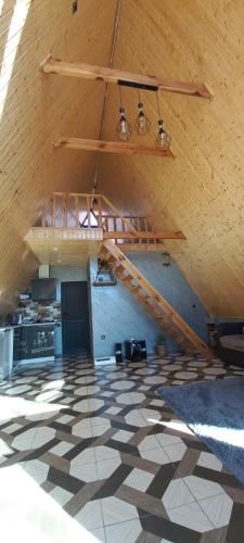 a large room with a staircase in a building at A Forest House in Dilijan