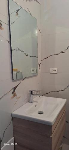 a bathroom with a sink and a mirror at Berat Feeling Guesthouse in Berat