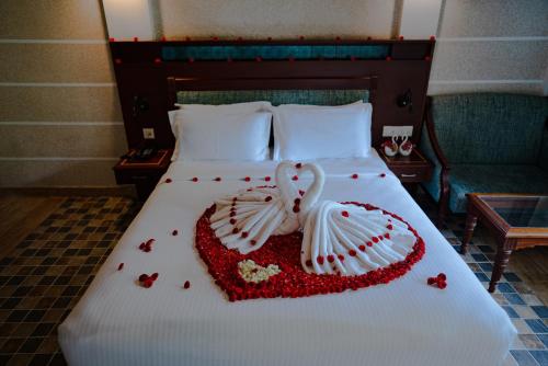 a bed with two swans made out of hearts at Indriya Sands in Cherai Beach