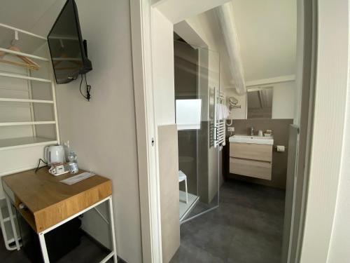 a small kitchen with a wooden table in a room at Boutique Hotel Nuovo Cason in Cavallino-Treporti