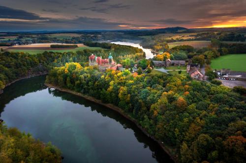 an aerial view of a castle in the middle of a river at Zamek Czocha in Leśna