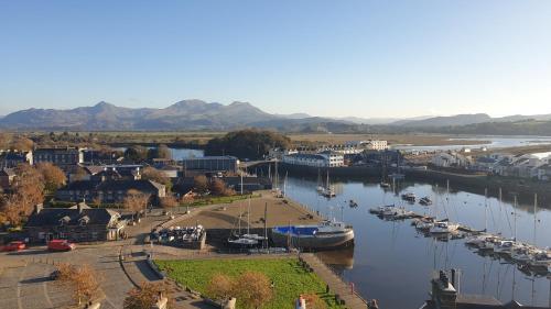 a marina with boats docked in the water at Harbour & Mountain Views, Porthmadog House, Sleeps 9, 4 Bedrooms, Two and Half Bathrooms in Porthmadog