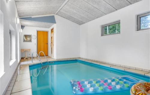a swimming pool with blue water in a house at Holiday Home Lærkevænget Ebeltoft V in Ebeltoft