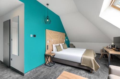 a bedroom with a bed and a blue wall at T62 Hotel in Budapest