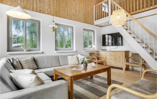 a living room with a couch and a table at Holiday Home Lærkevænget Ebeltoft V in Ebeltoft
