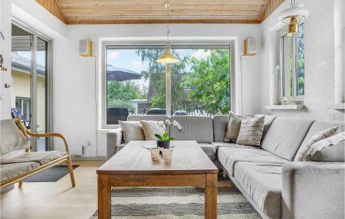 a living room with a couch and a table at Holiday Home Lærkevænget Ebeltoft V in Ebeltoft