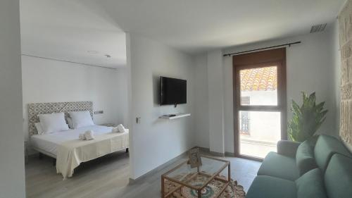 a bedroom with a bed and a tv and a couch at Selecta Marbella Sentire Apartaments in Marbella