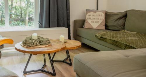 a living room with a table with candles on it at huis op de veluwe in Nunspeet