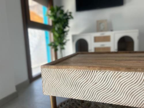 a close up of a wooden table in a room at Selecta Marbella Sentire Apartaments in Marbella