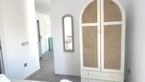 a white cabinet in a hallway with a mirror at Selecta Marbella Sentire Apartaments in Marbella
