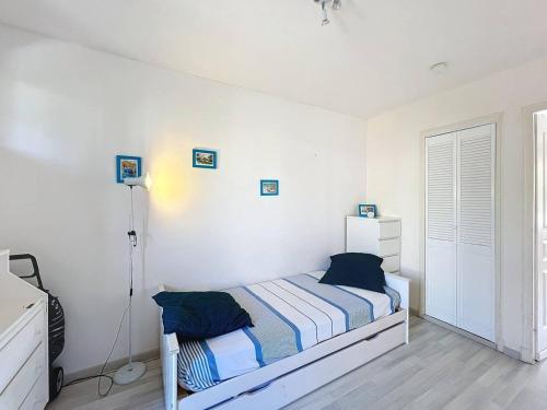 - une chambre blanche avec un lit et une lampe dans l'établissement T1 cosy avec terrasse et parking privé près de la plage des Lecques - FR-1-770-7, à Saint-Cyr-sur-Mer