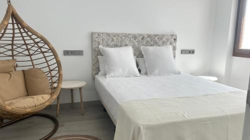 a bedroom with a swing bed and a chair at Selecta Marbella Sentire Apartaments in Marbella