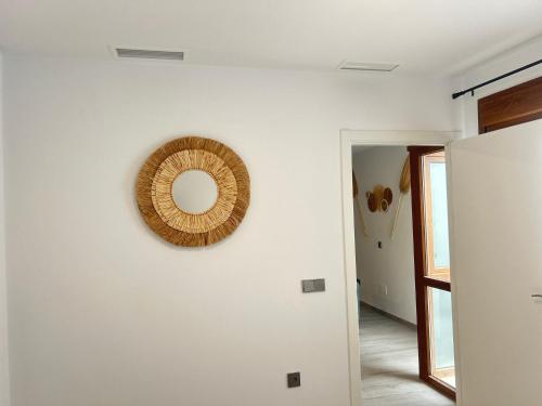 a room with a mirror on a white wall at Selecta Marbella Sentire Apartaments in Marbella