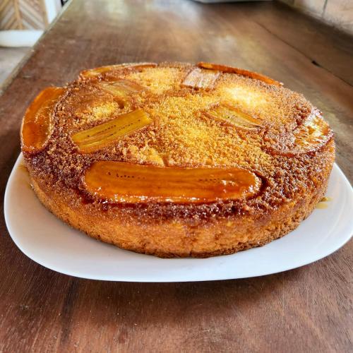 a cake sitting on a white plate on a table at Pousada Maresia in Atins