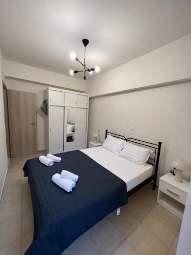a bedroom with a large bed with two towels on it at La Terra Luxury apartment in Kiveri