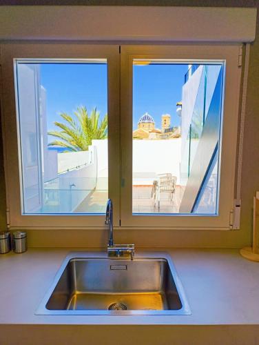 a kitchen sink with a view of a patio at Casabella La Terrasse in Altea