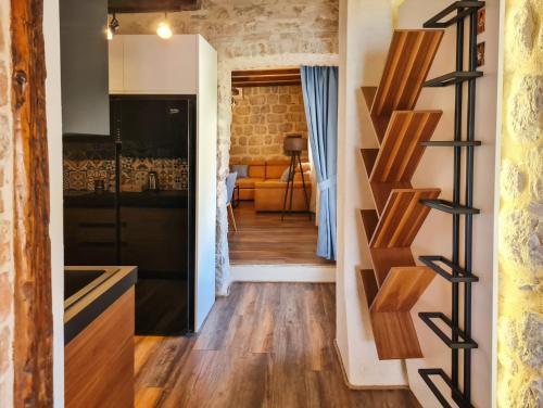 a kitchen and living room with a brick wall at Step to Kotor bay Perast in Perast