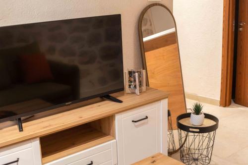 a large flat screen tv sitting on top of a cabinet at Step to Kotor bay Perast in Perast