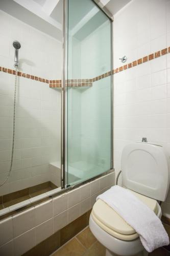 a bathroom with a toilet and a glass shower at Gardenia Junior Suite In Epidavros with Shared Pool in Néa Epídhavros