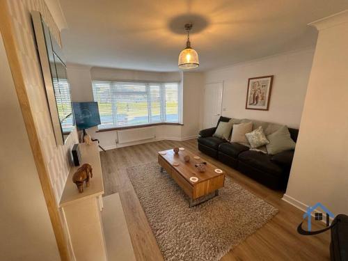 a living room with a couch and a coffee table at Beckleigh House, Kettering king or twin beds free parking x3 in Kettering