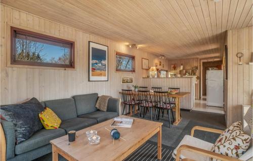 a living room with a couch and a table at Beautiful Home In Ørsted With Wifi in Ørsted