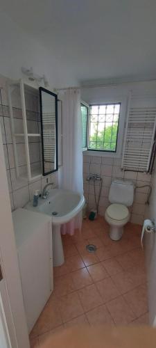 a bathroom with a sink and a tub and a toilet at Flat Panorama Sea View Studio for Couples Vrachos in Preveza
