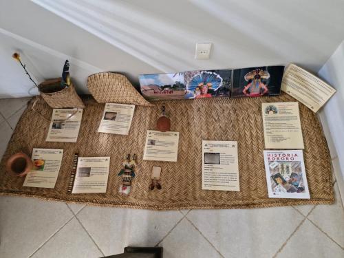 a table with pictures and information on it at Pousada Solar dos Pássaros in Rondonópolis