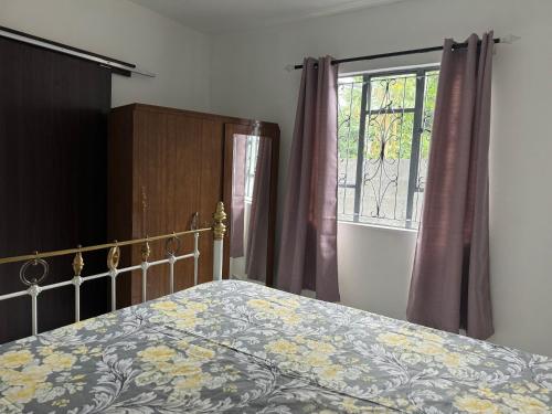 a bedroom with a bed and a window at Coastal Haven in Mahébourg