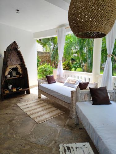 Ένα ή περισσότερα κρεβάτια σε δωμάτιο στο Diani Beach Cottage Apartment