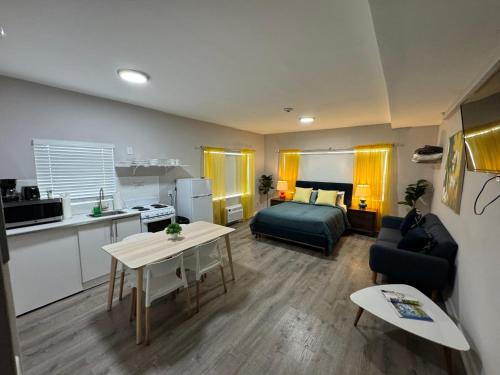 a living room with a bed and a kitchen at Miami International by Lowkl in Miami Beach