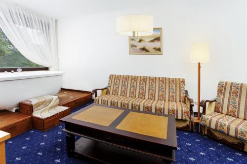 a living room with two chairs and a table at Park Villa Hotel in Vilnius