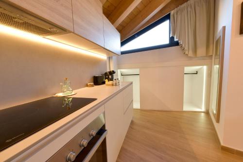 a kitchen with white cabinets and a sink and a window at ELS 4 PICS in Puigcerdà