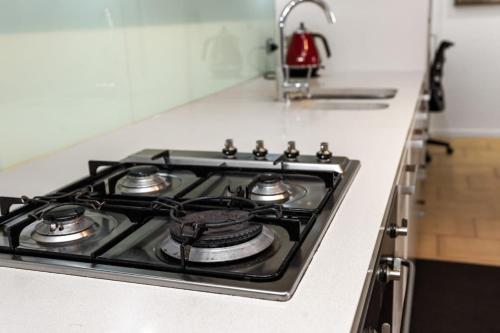 a stove top oven sitting on top of a kitchen counter at Woodys at the Waterfront in Darwin