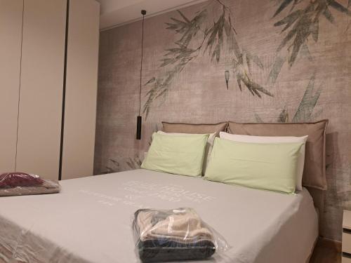 a bed with a bag sitting on top of it at Struttura Monte Olimpo in Porto Torres